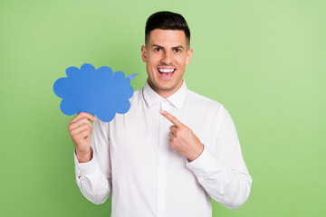 Photo of excited sweet young gentleman wear white shirt smiling pointing mind cloud isolated green color background