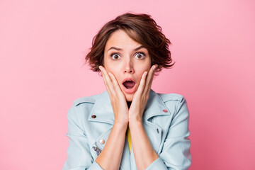Photo of young girl amazed shocked surprised fake novelty news hand touch cheeks isolated over pastel color background