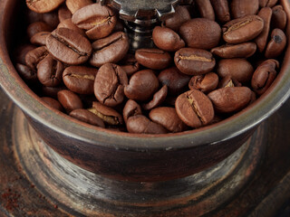 Vintage vintage retro bronze coffee Mill on a blue background with Roasted Coffee Beans