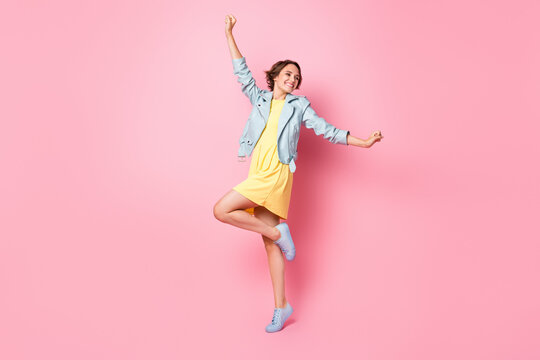 Full length photo of adorable sweet young lady wear teal leather jacket dancing isolated pink color background