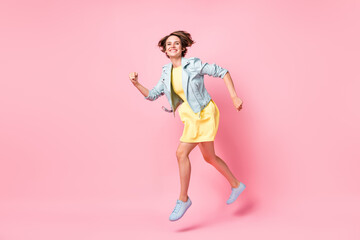 Fototapeta na wymiar Full size profile side photo of young beautiful happy cheerful positive girl running in air isolated on pink color background
