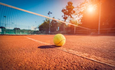 Acrylic prints Best sellers Sport Wide angle close-up photograph of tennis ball on court during sunset. Competitive individual sports concept. 