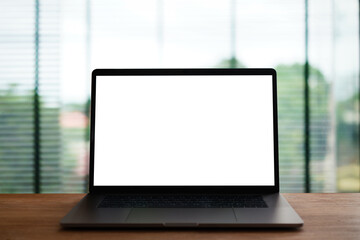 Laptop with screen on the table,office background for light bokeh.	
