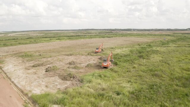 Malaysia, June 07, 2020 : Aerial view of backhoe is digging grove in the agricultural garden area to grow durian aerial. 4k footage