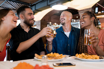 Group of friends enjoying a meal together at a restaurant.