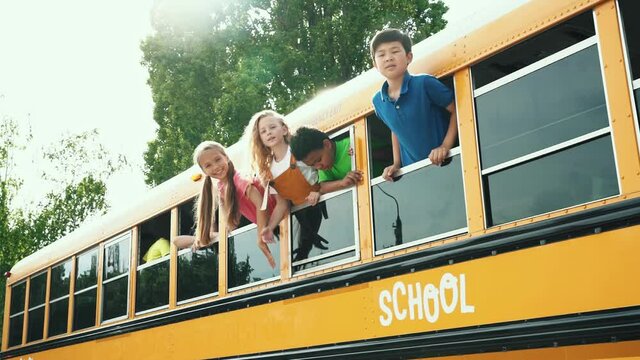 Children studying and having fun at school. Multiethnic group of kids going on a school trip with the bus