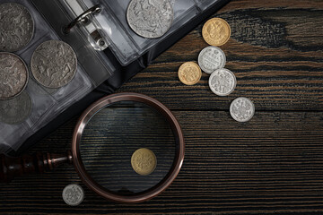 Numismatics. Old collectible coins of silver, gold and copper on the table. - obrazy, fototapety, plakaty