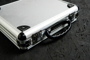 Metal aluminum briefcase on a black background.