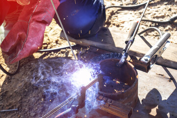 Close-up of welding work. An electric welder welds a metal product.
