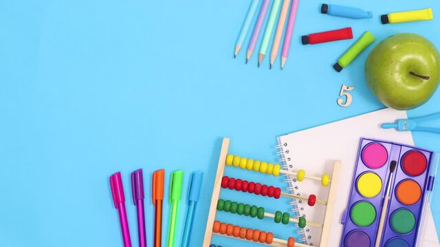 Back to school stationery with clock appear on right side of blue theme. Stop motion