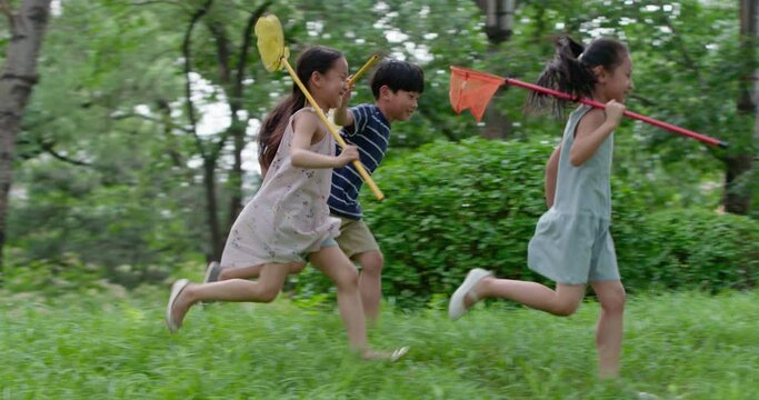 Three children playing on grass,4K
