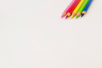 colored pencils on a white background copy the space. pencils for drawing on a white sheet of paper
