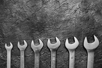 Set of wrenches on a concrete background.