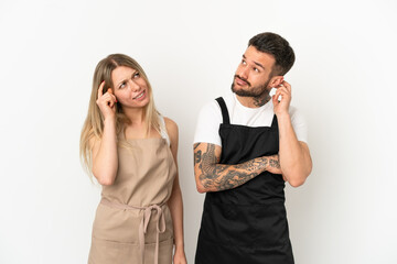 Restaurant waiter over isolated white background thinking an idea while scratching head