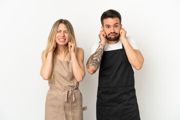 Restaurant waiter over isolated white background covering both ears with hands