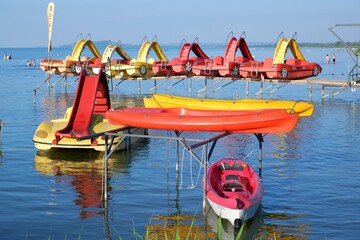 colorful kayaks and pedal boats on the blue water of the lake Balaton in Hungary in summer July