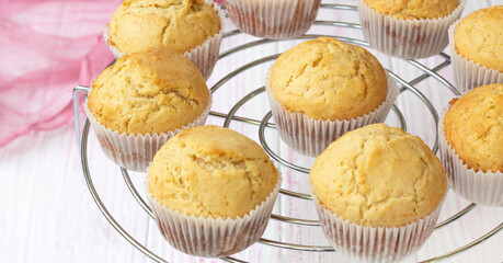 Selective focus. classic homemade muffins are cooled on a wire rack to cool. Fresh vanilla cupcakes close up. Vanilla baked goods. High quality photo