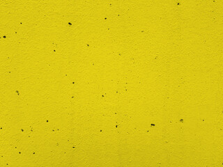 Solid yellow color plaster concrete wall texture background.