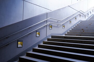modern concrete stairs with metal railing and lamps in grey color