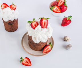 Easter cake made of chocolate dough, decorated with meringues and strawberries. Easter decor on white background 