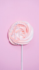 Beautiful cake roy meringue on a stick on a pink background
