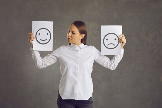 Woman shows happy satisfied and sad unhappy emotional intelligence picture cards trying to understand, choose, change or control different emotions, mind.