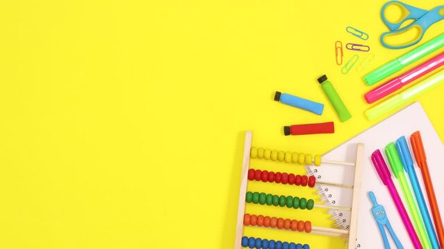 Vibrant school stationery appear on right side of yellow theme. Stop motion