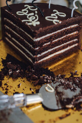 sliced devil's food layer chocolate birthday cake on gold 
