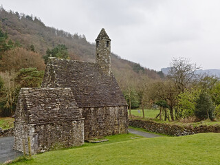 Fototapeta na wymiar Saint Kevin Medieval church in the valley of of Glendalough on a foggy day, Dublin mountains,Wicklow county, Ireland 