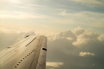 blue sky background with white clouds. Puffy clouds horizon. View from the airplane window on the wing.