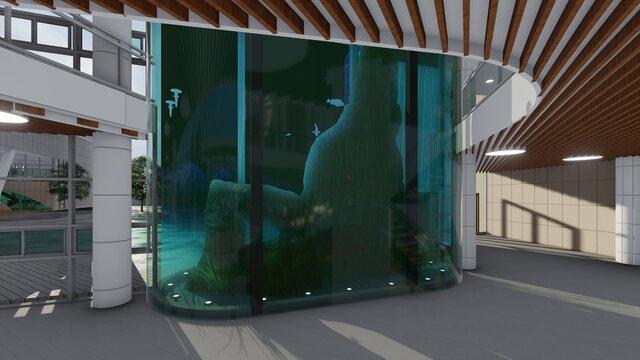 Espacio interior con acuario de doble altura decorado con rocas de mar y peces de agua salada