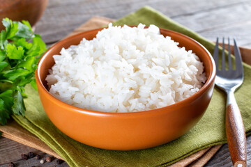 Cooked rice in a bowl on an wooden table