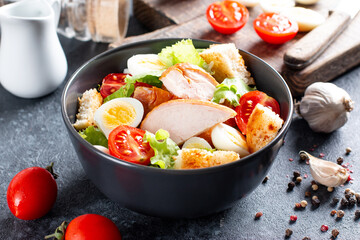 Chicken salad. Chicken Caesar Salad. Caesar salad with smoked chicken on a plate. Grilled chicken breasts and fresh salad