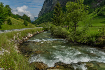 Fototapeta na wymiar Grossarler Ache river in sunny cloudy morning in Austria