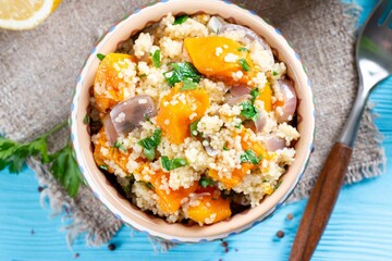 Autumn Couscous with pumpkin and vegetables on table. Top view.