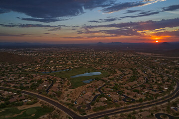 An aerial view of the sun setting over the Arizona desert in the summer.
