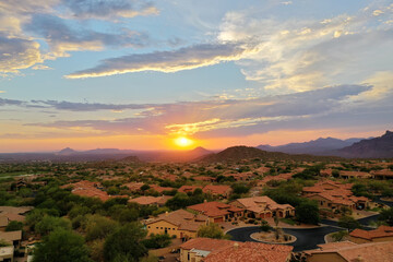 An aerial view of the sun setting over the Arizona desert in the summer.