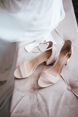 Beautiful wedding shoes. Gentle wedding picture. Pink wedding shoes with bride in the background. Modern wedding concept.