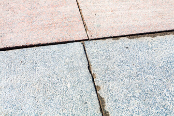 Street tiles with obvious joints. Gray and light red colors.