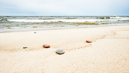A few sea rocks on a sandy beach
