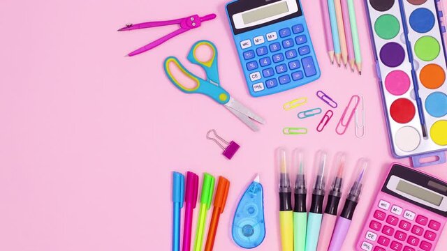 Pastel vibrant back to school accessories appear on pastel pink theme. Stop motion