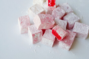 Sweet pieces of turkish delight on white background