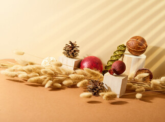 Beautiful handmade composition of cereals, cones, Christmas tree decorations, boxes. Preparing for Christmas, New Year, family celebration. Beige tones. High angle view.