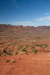 The steep canyon. Panorama view of the red desert, cliffs, orange sandstone formations and rocky mountains in the horizon in Sierra de las Quijadas national park in San Luis, Argentina.	