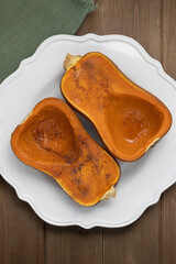 Roasted winter squash dessert on white plate viewed from above