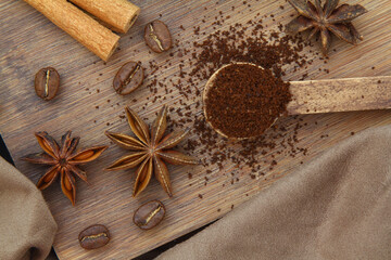 Coffee beans, cinnamon sticks, anise and wooden spoon close-up