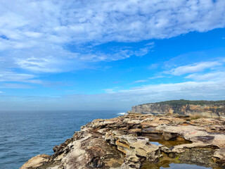 Fototapeta na wymiar Coastal cliffs looking over the ocean on a sunny day.