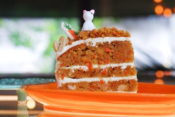 A slice of carrot cake on a dish.