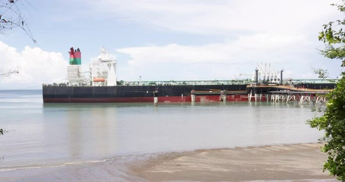 Panama, Limones beach, an oil tanker ship at anchor, at the oil terminal on the border with Costa Rica. 