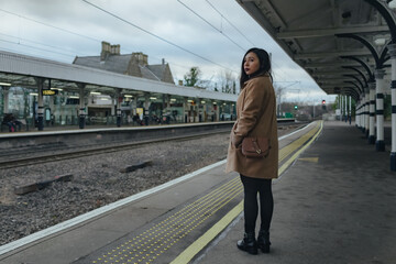 Young latin woman waiting at the train station